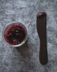 large wood spreading tool with red jam