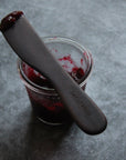 large wood spreading tool with red jam