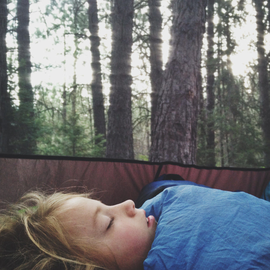 child sleeping in a tent