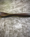 Small wooden spoon on gray background