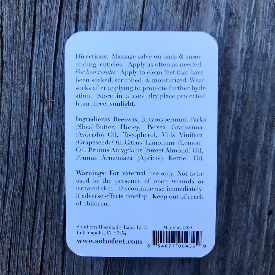 The packaging for the cuticle salve is displayed on a wooden surface. 