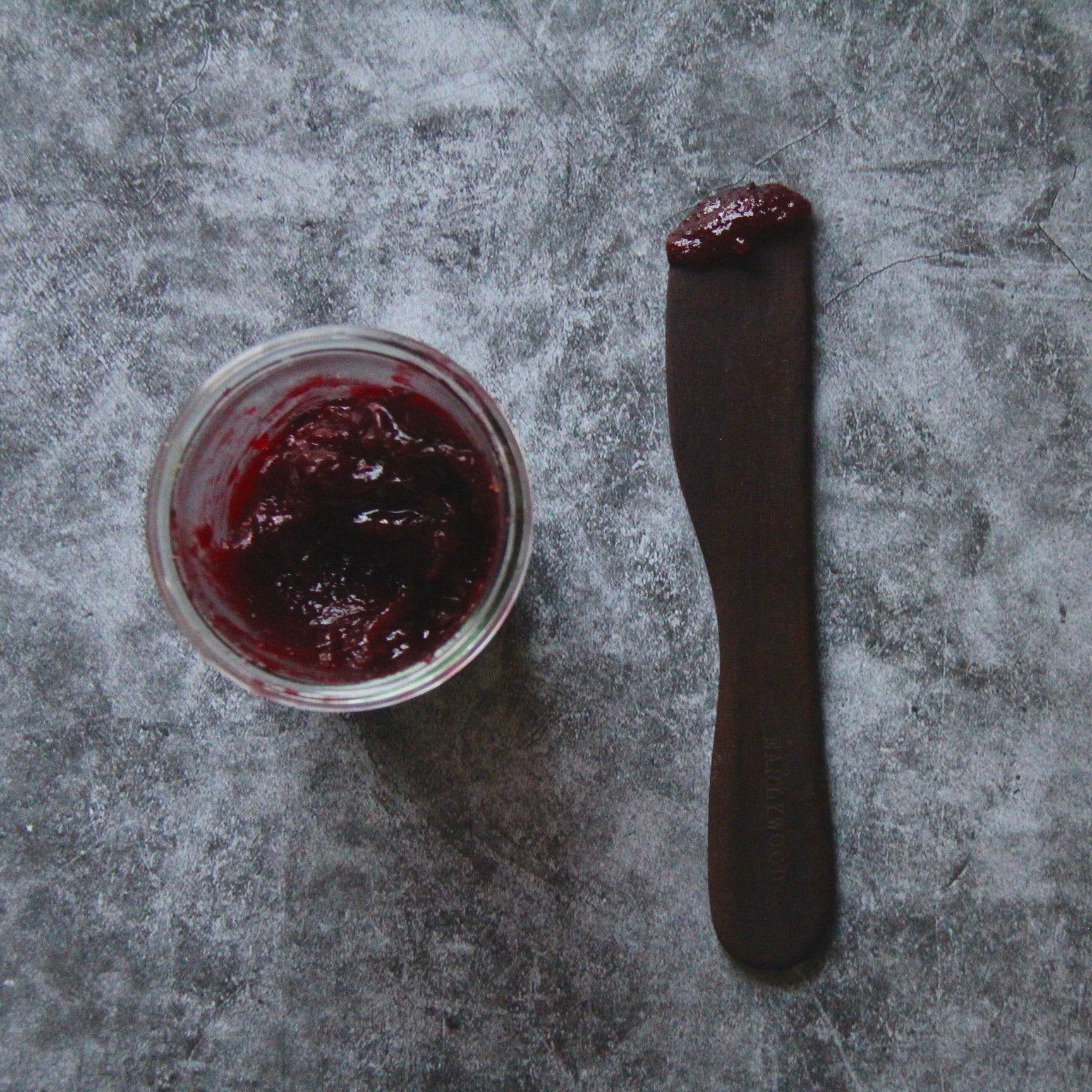 large wood spreading tool with red jam 